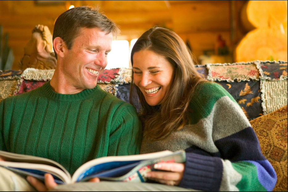 couple smiling and reading together